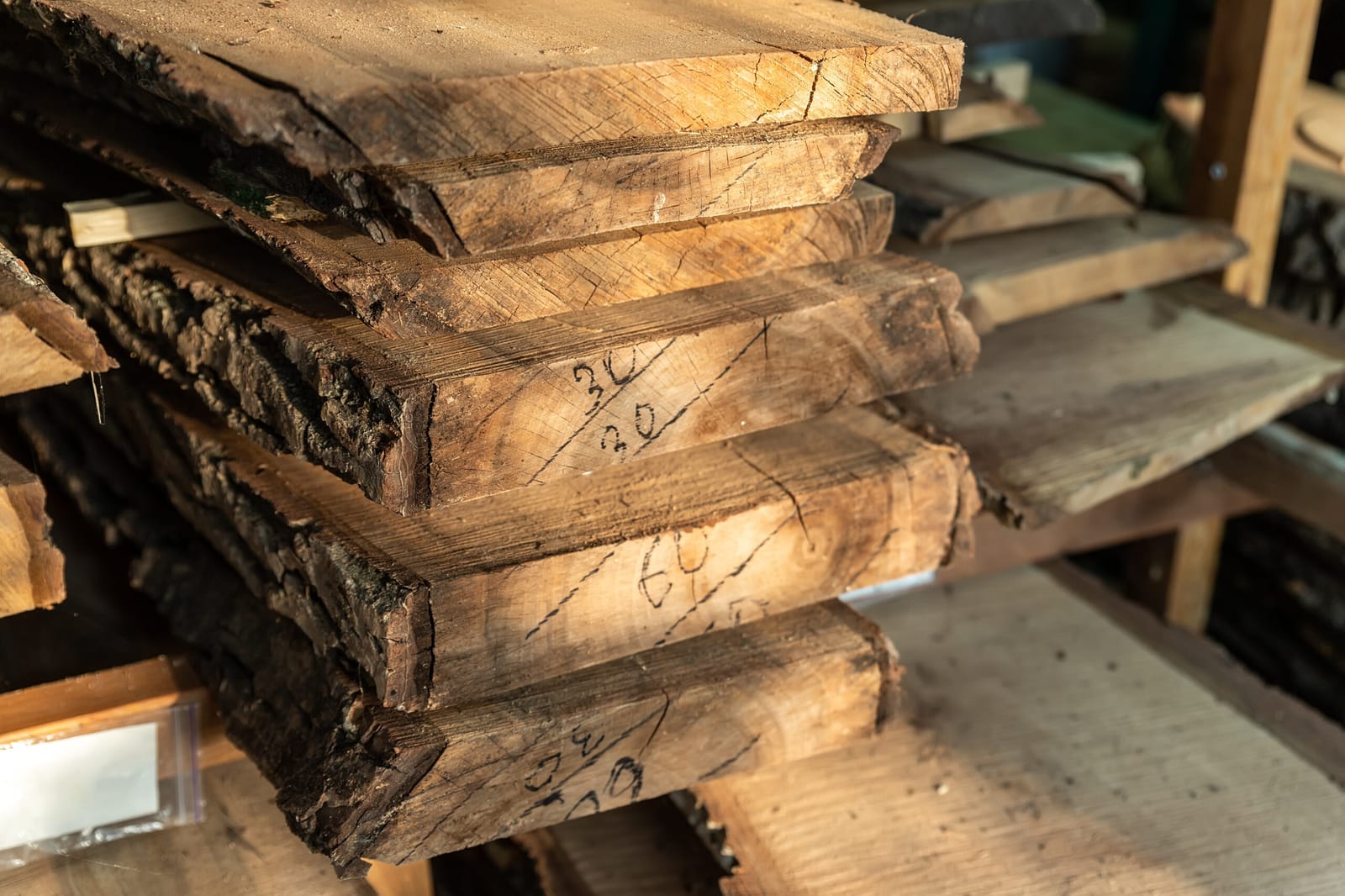 Live-edge rough-cut lumber slabs milled to order, marked with dimensions